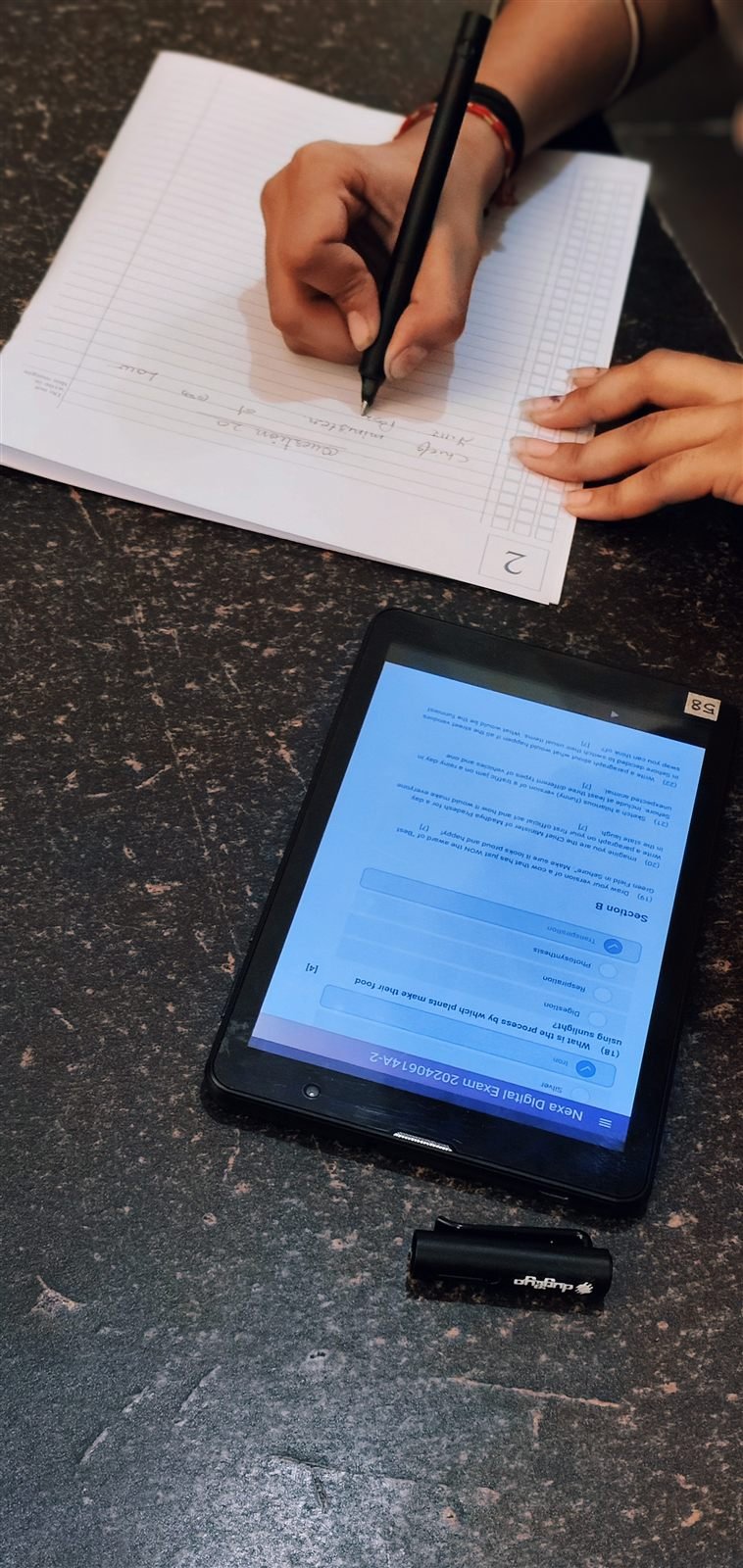 Digital question paper, paper answer booklet — both at once.