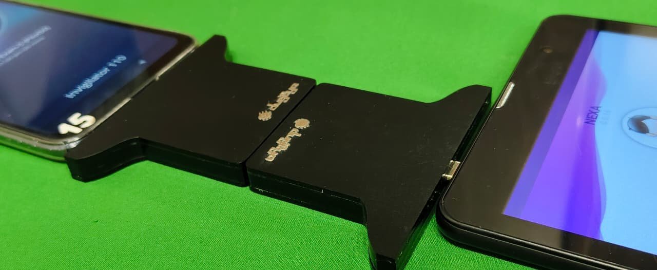 Angled view of the mated Relay Cards between an invigilator phone and a candidate tablet